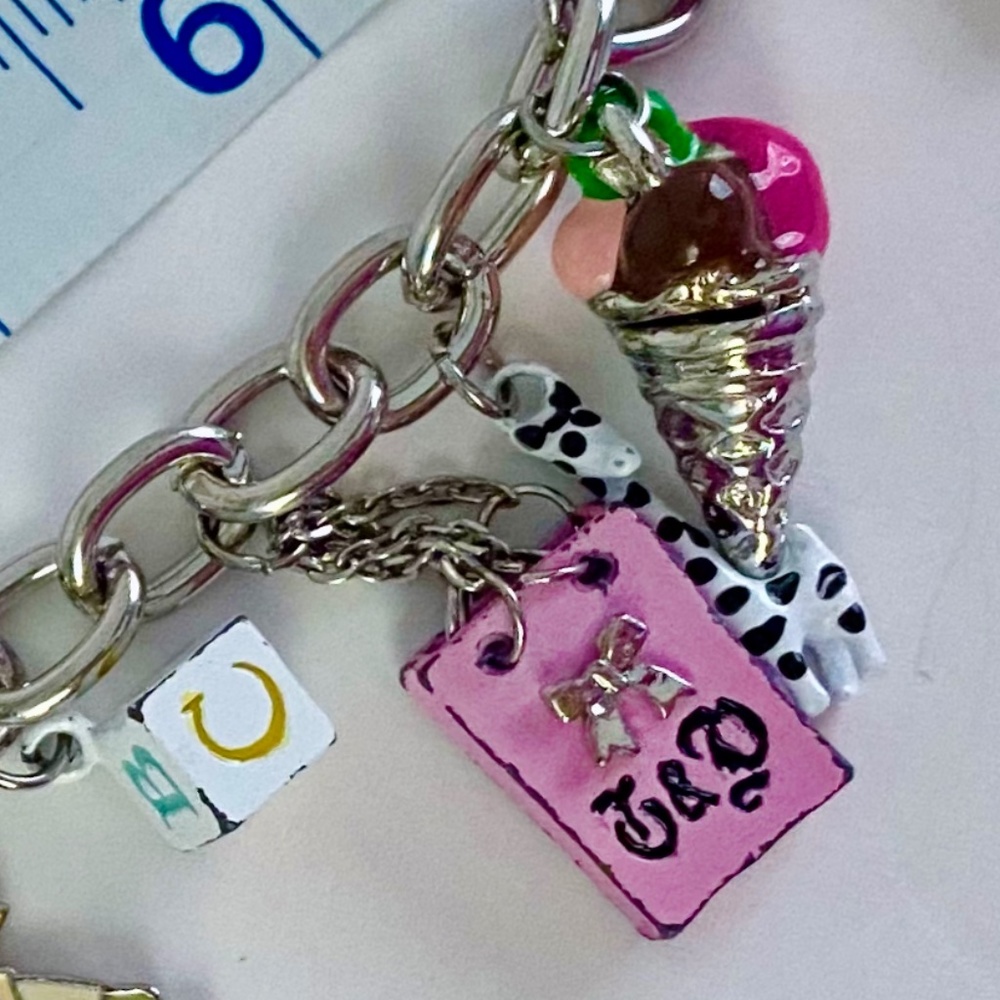 Juicy Couture Silver Charm Bracelet with Pink and Gold Accents - Picture 7 of 7